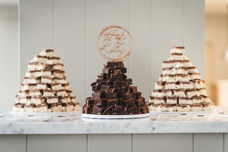 A stack of brownies flanked by two stacks of millionaire's shortbread at a wedding