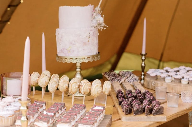 A rustic wedding dessert table at a tipi wedding