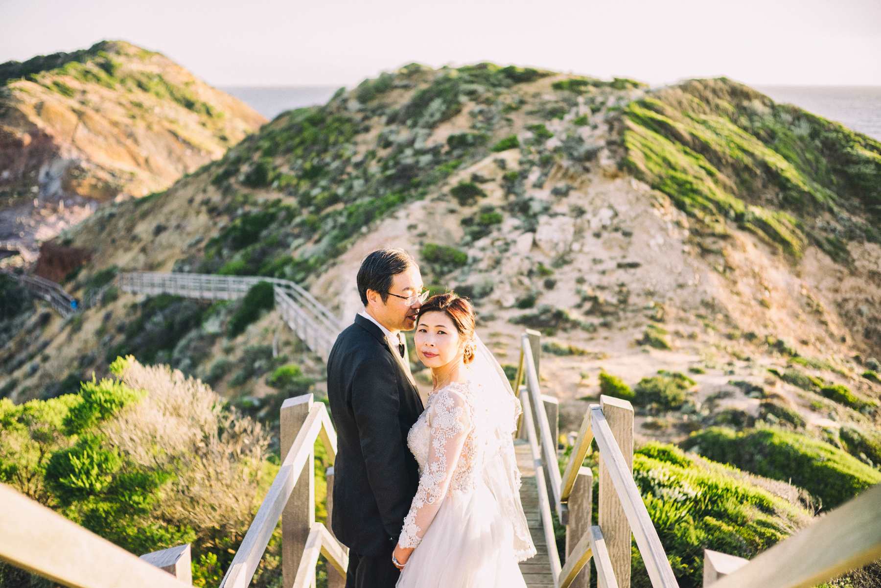 Bride and groom posing in the hills of Australia