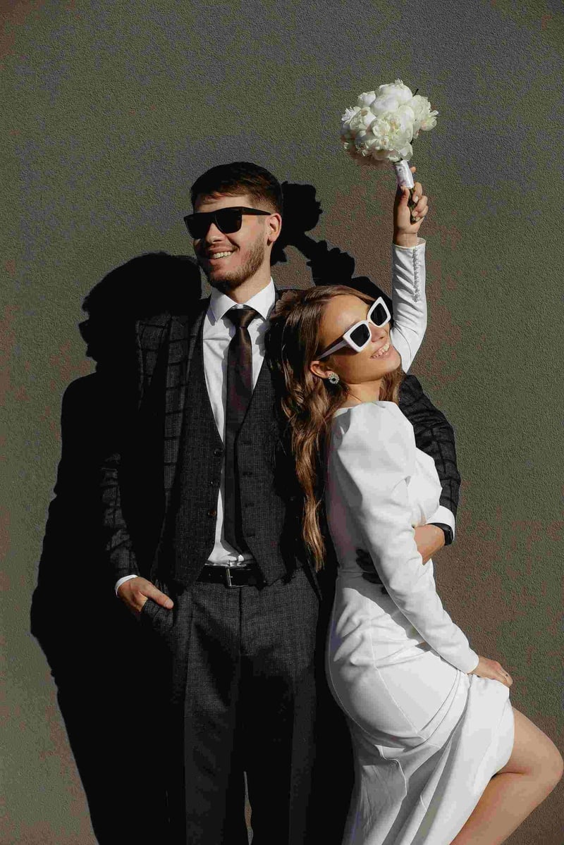 Bride and groom joyfully posing in sunglasses at a contemporary style wedding