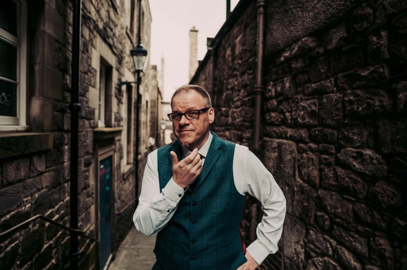 portrait shot of a wedding magician looking into the camera.
