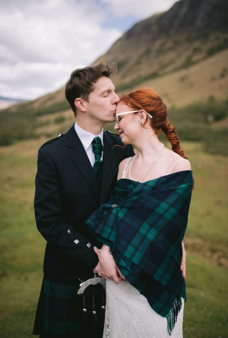 Bride and groom posing together  in the scottish highlands