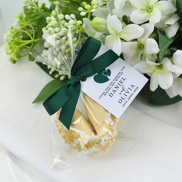 a fortune cookie wedding favour wrapped in cellophane with personalised label.