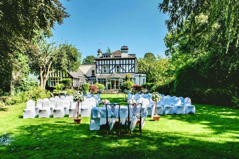 Brook Hall Hotel exclusive-use wedding venue, Tudor-style exterior with outdoor ceremony seating, Cheshire