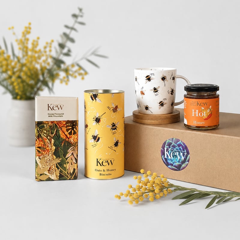 a gift box from Royal Botanic Gardens Kew featuring a bee-themed mug and honey-themed treats.