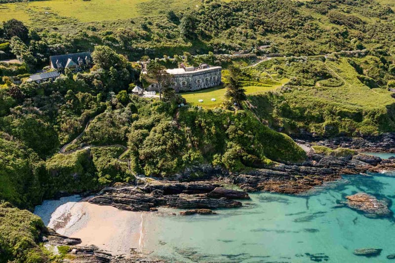 Aerial view of coastal wedding venue Polhawn Fort with the sea and the beach in the foreground