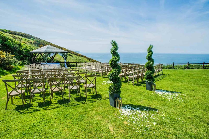 Outdoor wedding ceremony set up overlooking the sea at beach wedding venue Ocean Kave