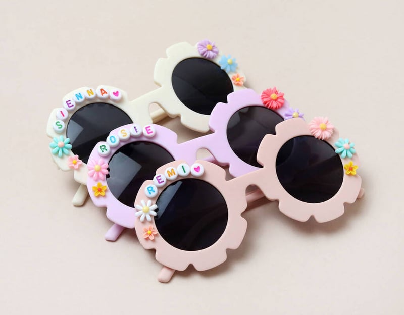 four pairs of personalised flower shaped children's sunglasses.