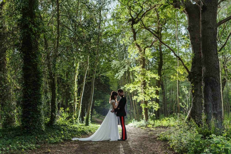 Bride and groom kissing in the wood at Tournerbury Estate
