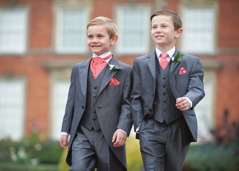 two little boys wearing grey morning suits with pink cravats.