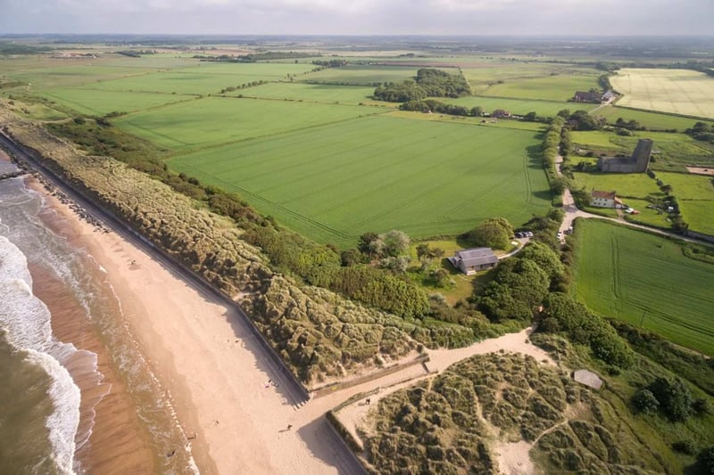 Aerial view of beach side barn wedding venue on the norfolk coast