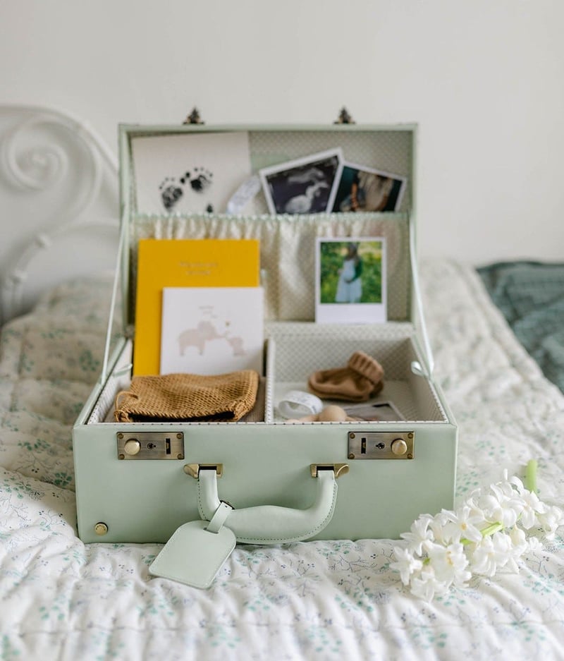 a memory case on a bed filled with photos and letters.