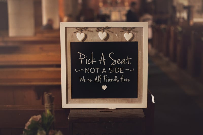 a chalkboard sign that reads 'pick a seat not a side'