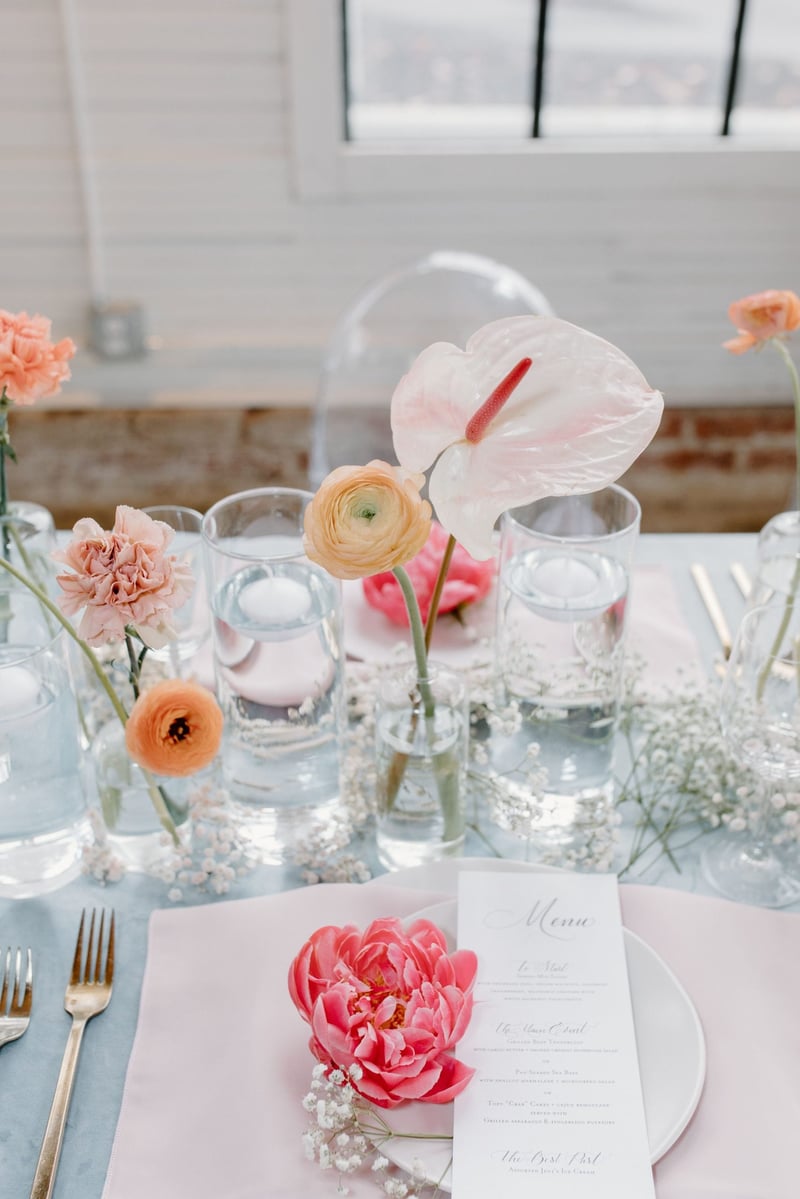 a wedding place setting with flowers 
