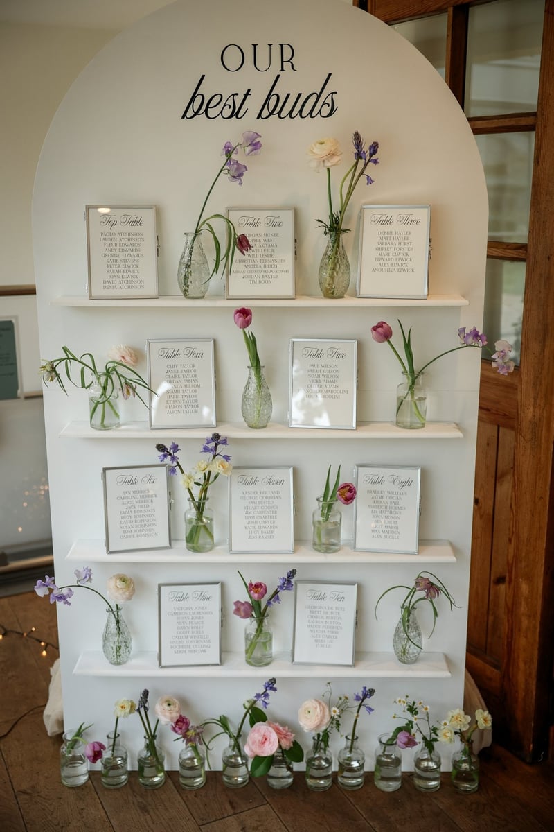 a DIY wedding table plan with bud vases and guest names listed in photo frames.
