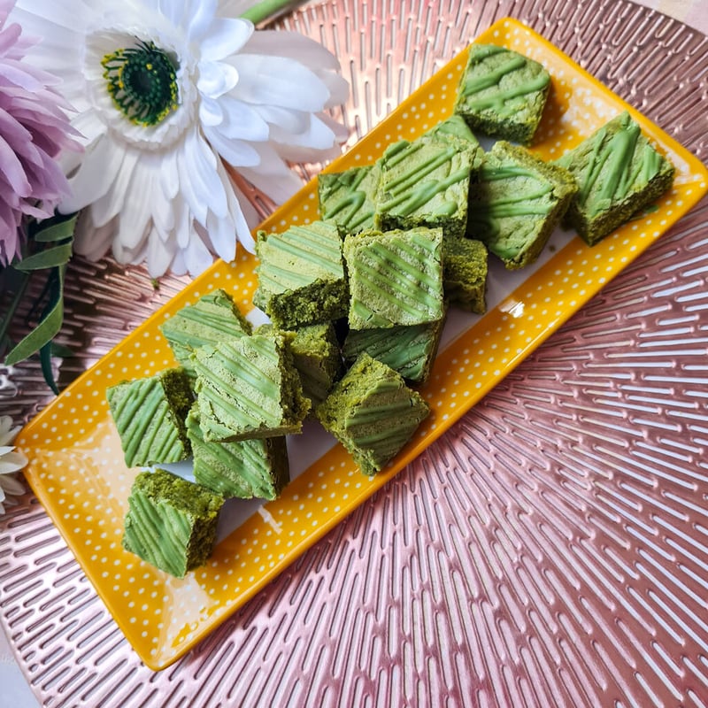 a yellow rectangular plate filled with matcha blondies.