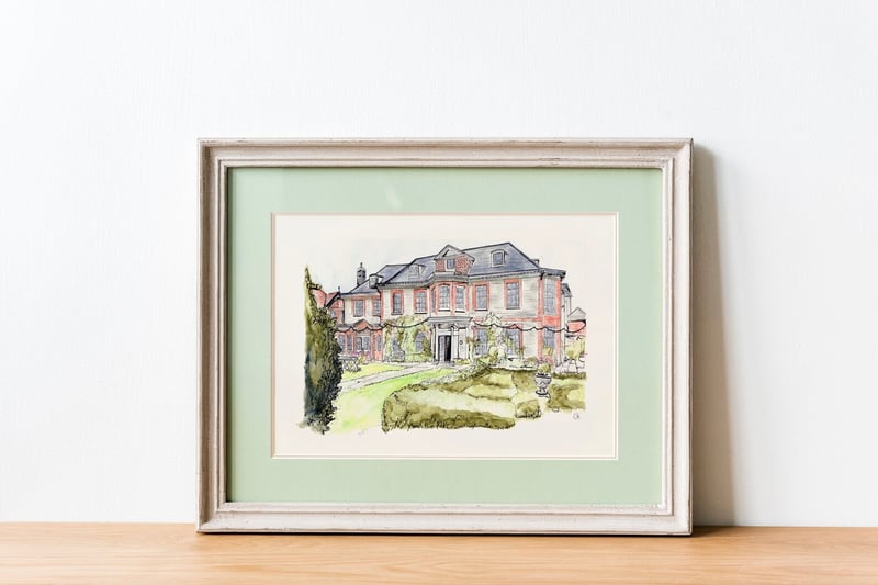 a framed watercolour illustration of a wedding venue.