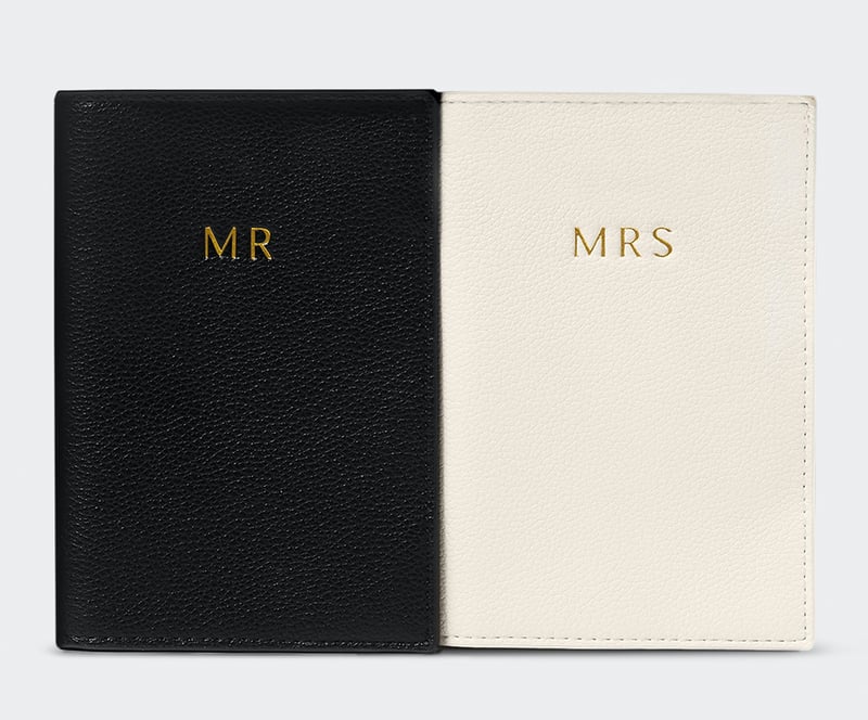 black and cream faux leather passport holders embossed with mr and mrs in gold lettering.