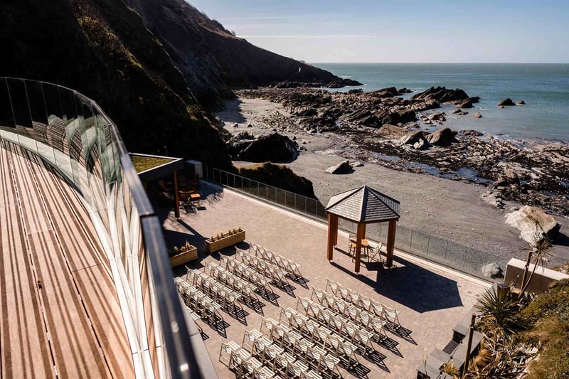 Aerial view of the beach wedding ceremony set up at coastal devon wedding venue Tunnels Beaches