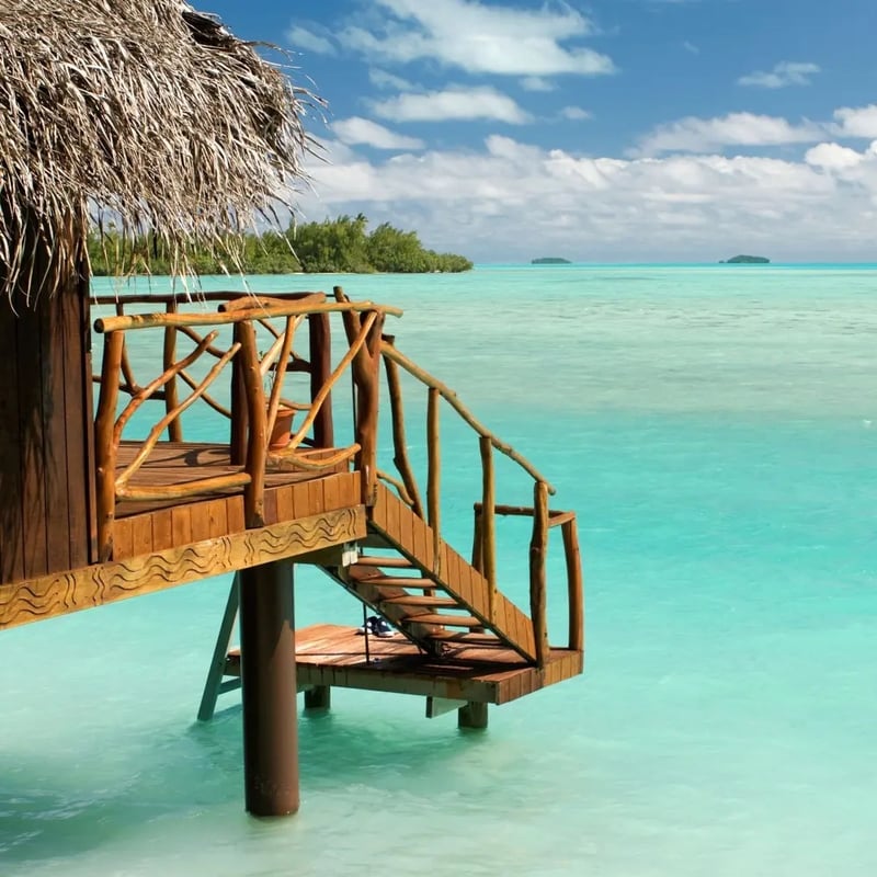 a turquoise ocean with over-water hut honeymoon accommodation. 