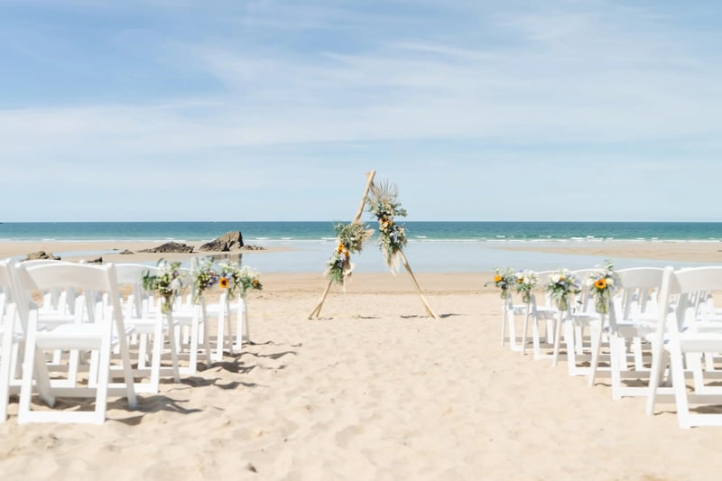 Beach wedding ceremony  set up on the sand with the sea in the background