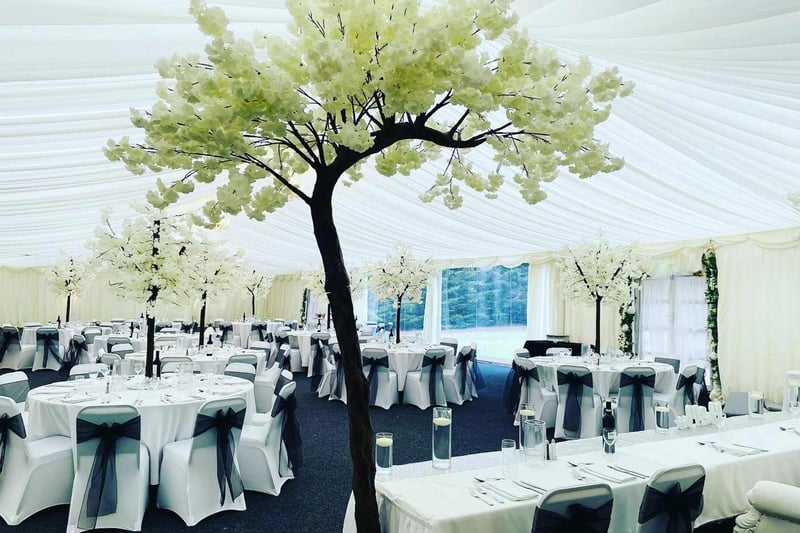 A tree indoors at a marquee at The Grand Marquee Brentwood set up for a wedding reception