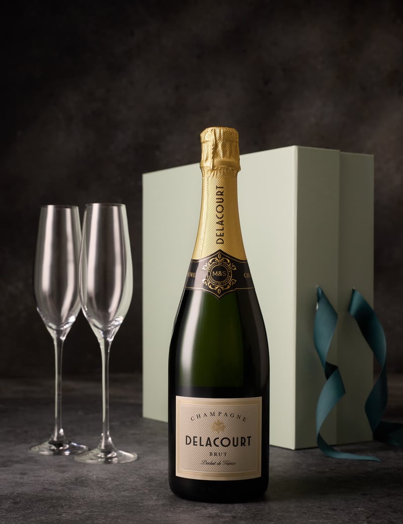 a bottle of champagne and two glass flutes.