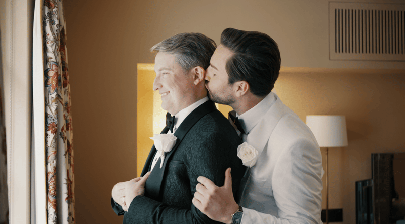two grooms embracing as they get ready for their wedding day.