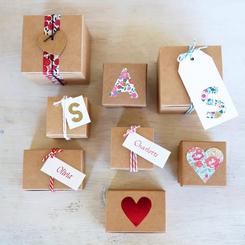 a selection of kraft boxes in different sizes personalised with different initials and details.