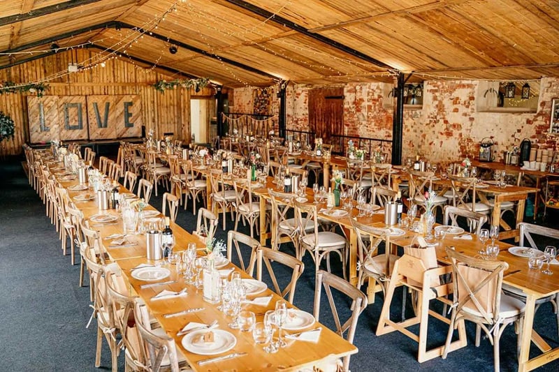 Stanford Farm exclusive-use wedding venue, rustic barn reception with long tables and fairy lights, Shropshire