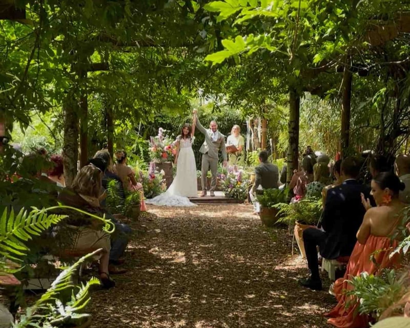 Bride and groom celebrating after an outdoor forest wedding