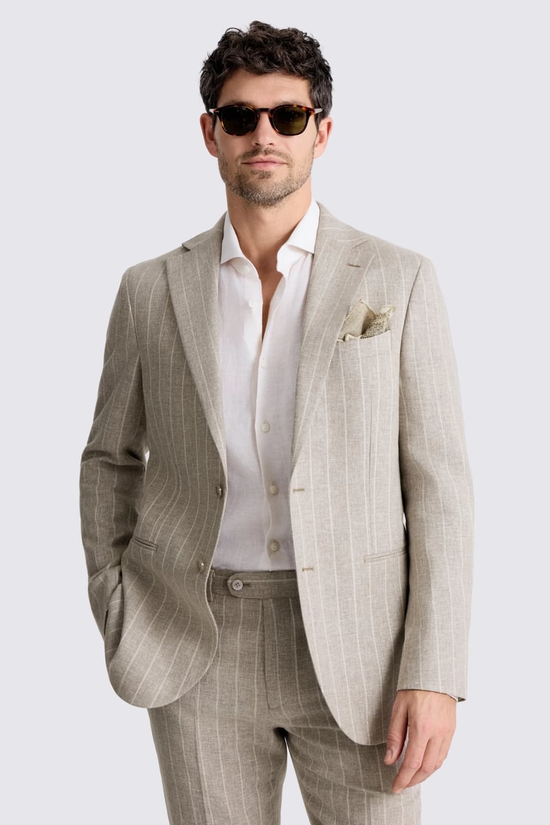 a male model wearing a striped linen taupe suit with a white shirt and sunglasses.