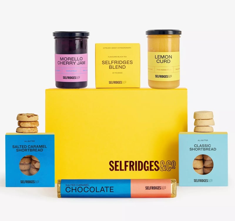 a yellow Selfridges box featuring afternoon tea items.