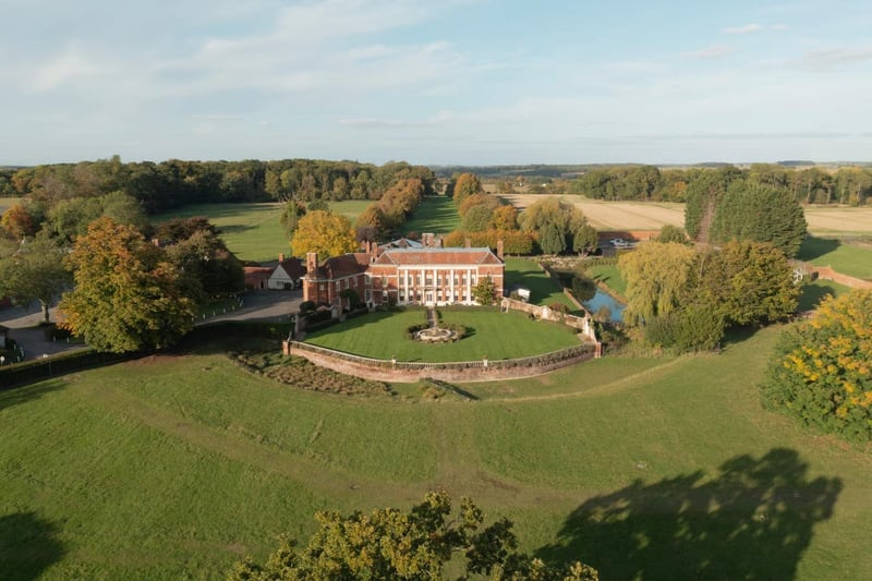 Aerial view of a Georgian manor house wedding venue surrounded by parkland and gardens