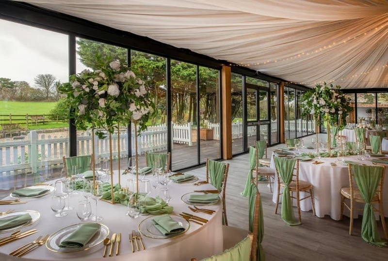 A wedding reception set up at solton manor with green chair sashes and matching napkins