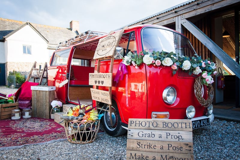 a red VW camper turned into a wedding photo booth.