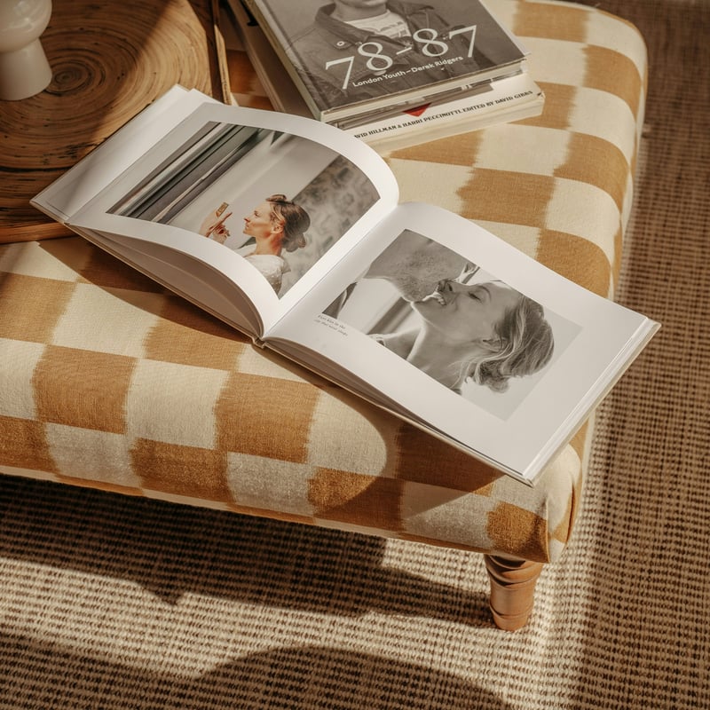 an open wedding album on a couch.