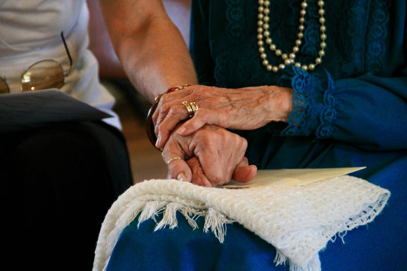 old couple holding hands 