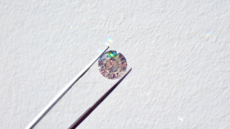 diamond being held up to the camera in tweezers