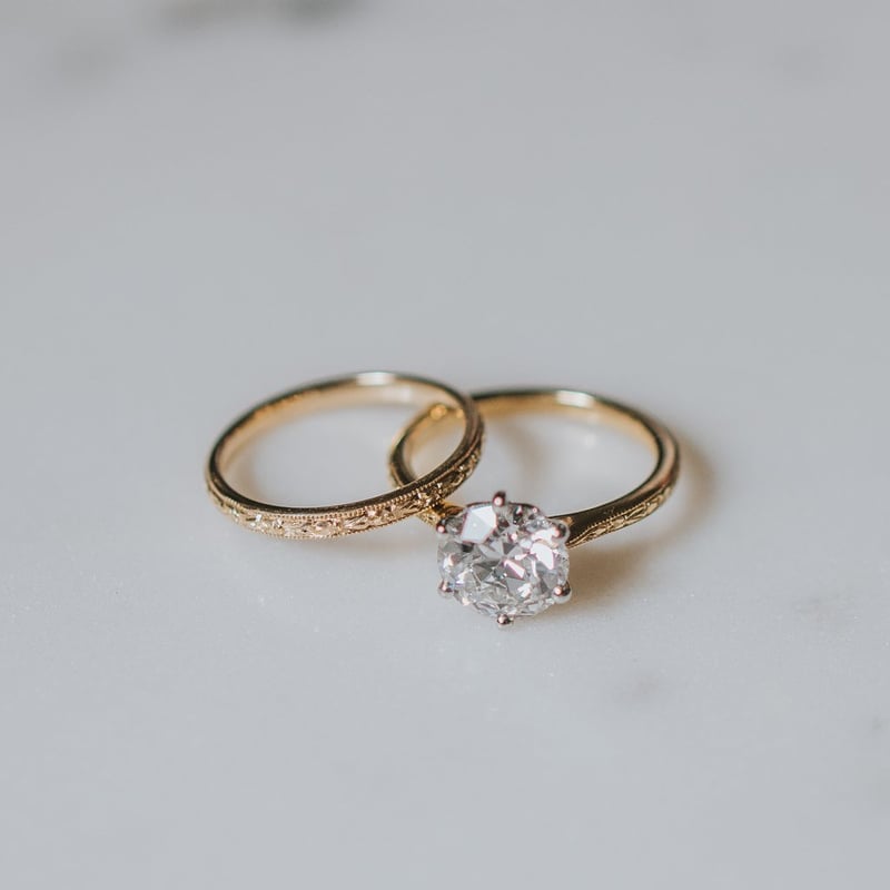 a diamond and yellow gold engagement ring and matching wedding ring.