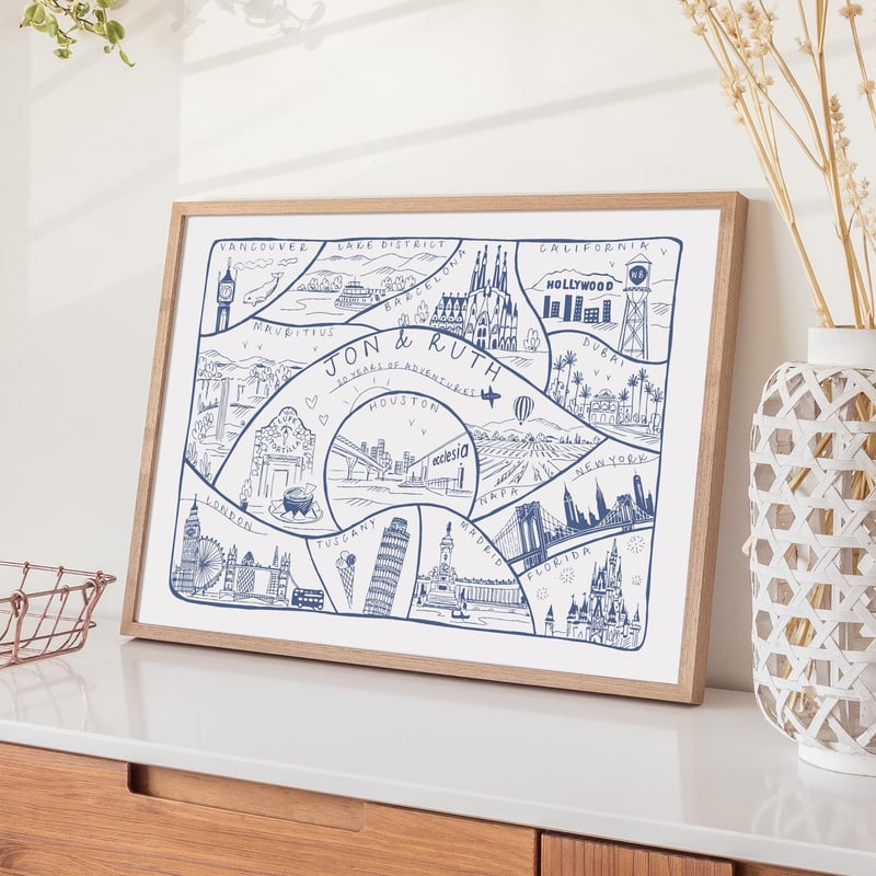 a blue and white map print framed in wood.