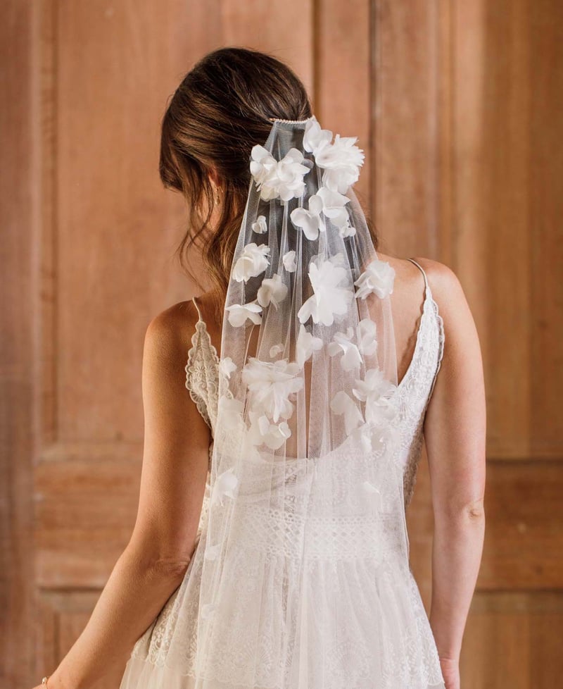 a bride wearing a barely there floral veil.