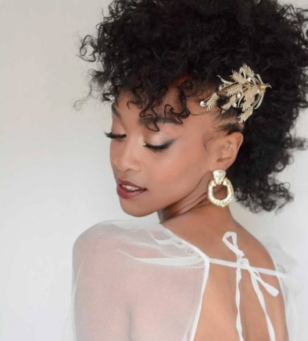 a black bride with afro texture hair wears an ornate gold hair comb.