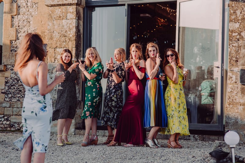 a group of party guests pose for a photo.