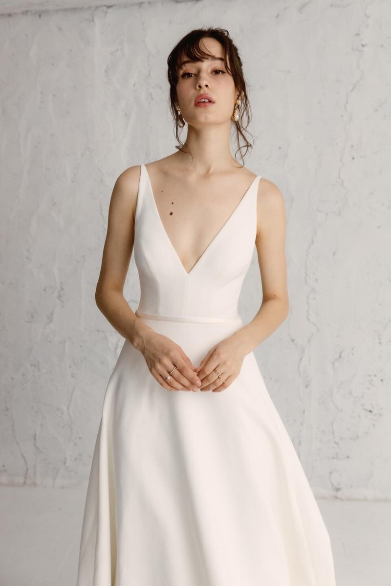 a model wears a strappy v-neck wedding dress.
