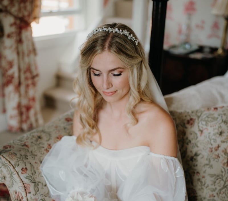 a blonde-haired bride wearing her hair down with a sparkly headband.