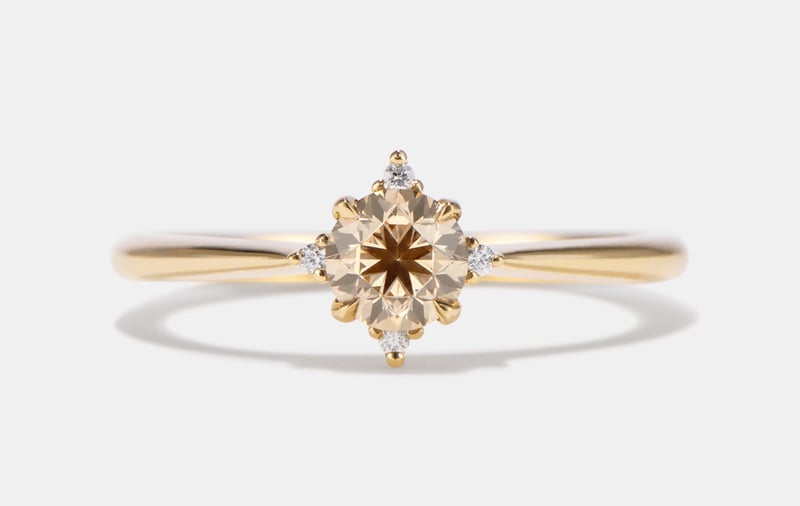 a champagne diamond cluster ring with yellow gold band.