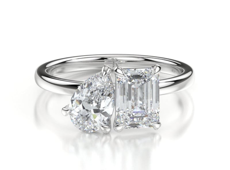 a platinum diamond toi et moi engagement ring.