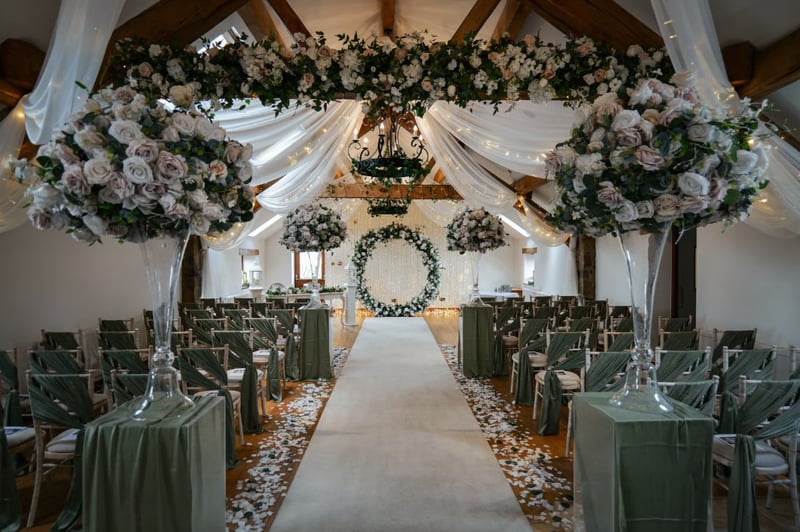 a historical barn set up for an indoor wedding ceremony 