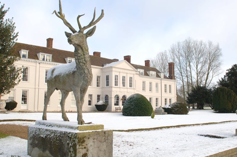 exterior of a country house wedding venue in the snow.
